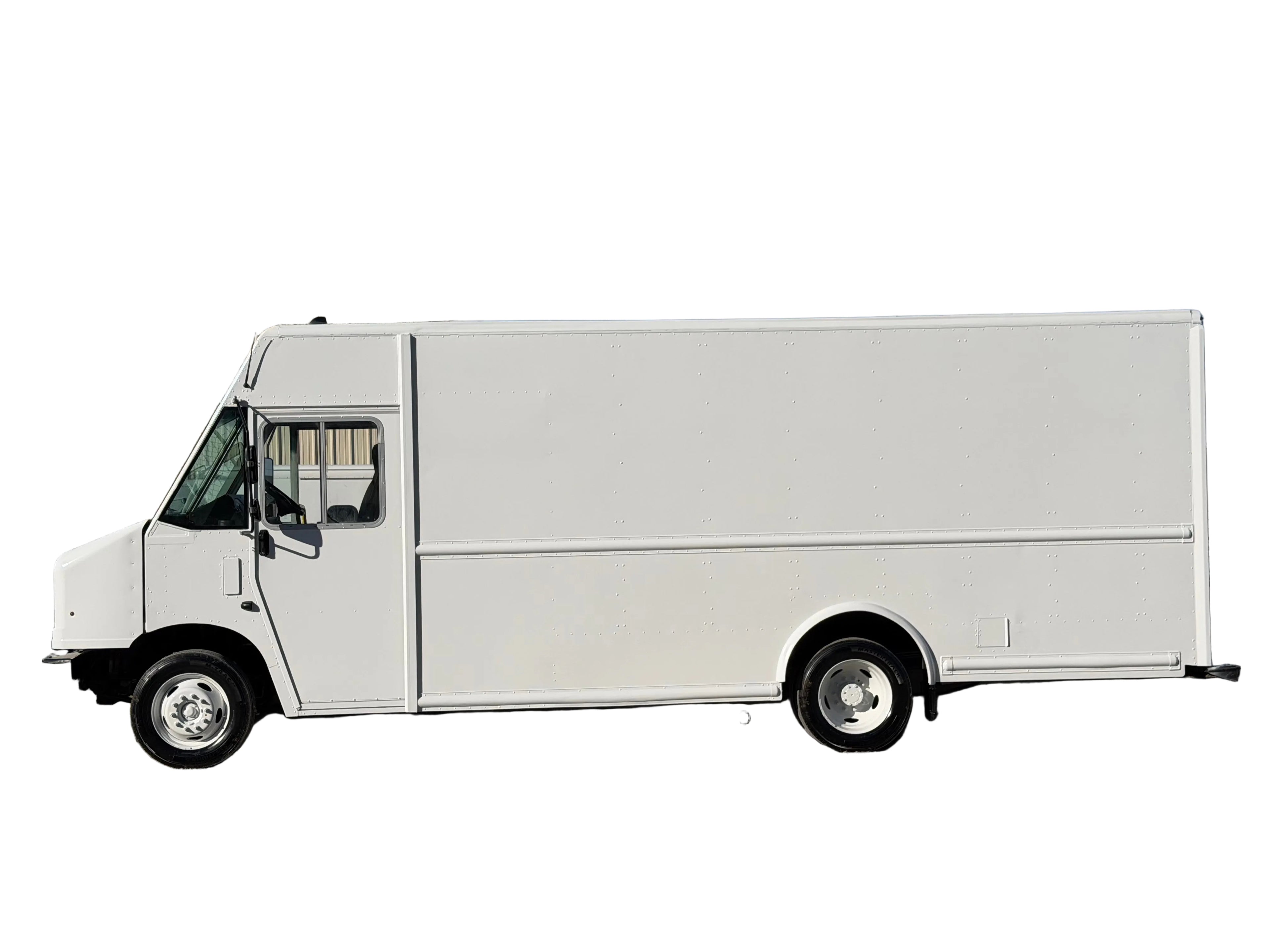 White delivery truck parked on a gravel surface with a building in the background stepvan for sale made in america made in Texas 